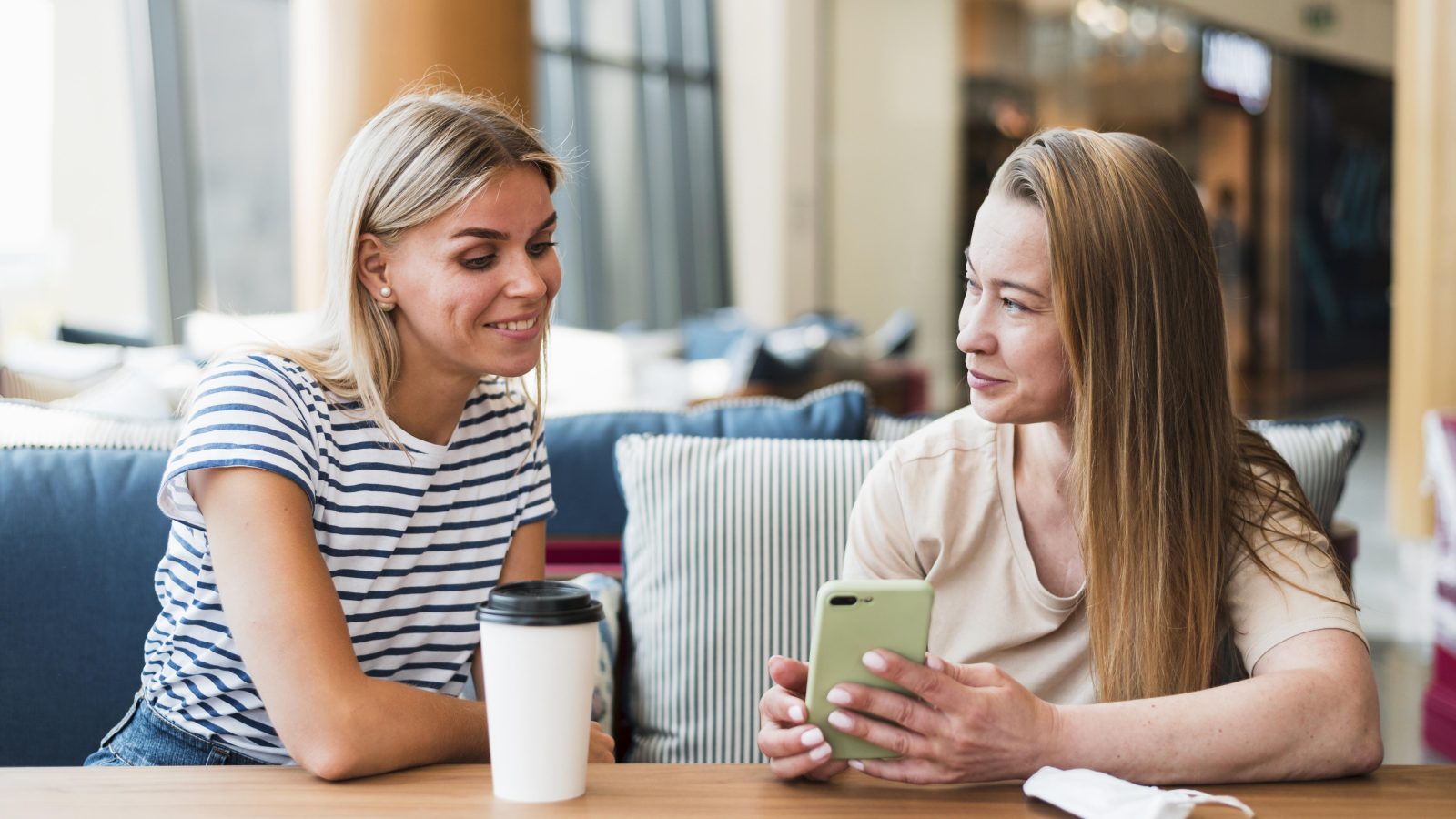 Two woman talking together over coffee