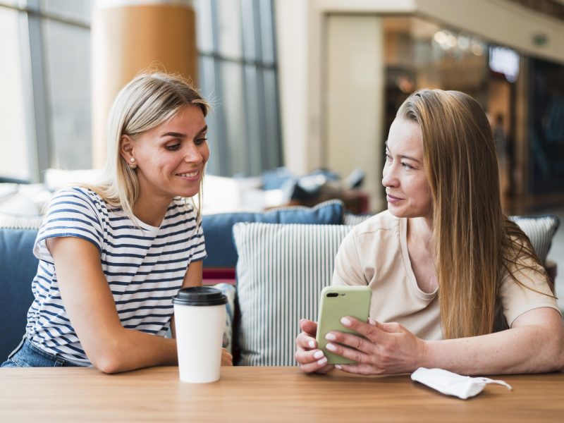 Two woman talking together over coffee