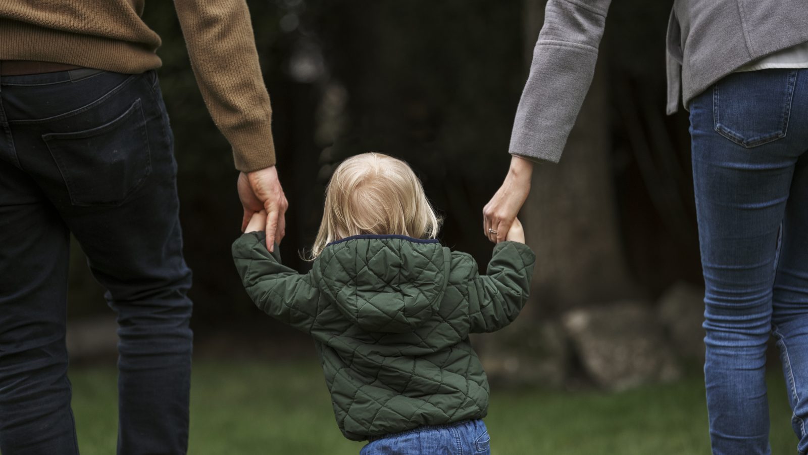 Parents walking while holding kids' hands